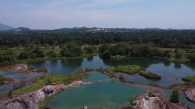 aerial scene of the granite hill looking down on the abandoned mine ponds.