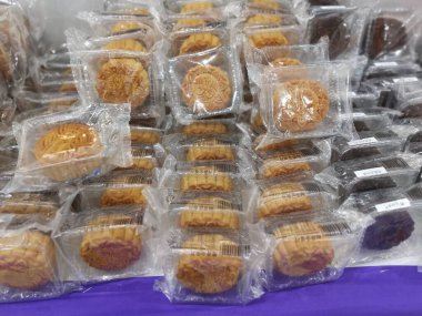 Perak,Malaysia.August 18,2022: Displaying variety brands of Malaysian mooncakes food products on the shelf for sale for the coming Mid-Autumn festival in Aeon Supermarket Sri Manjung.