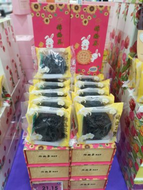 Perak,Malaysia.August 18,2022: Displaying variety brands of Malaysian mooncakes food products on the shelf for sale for the coming Mid-Autumn festival in Aeon Supermarket Sri Manjung.
