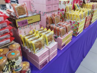 Perak,Malaysia.August 18,2022: Displaying variety brands of Malaysian mooncakes food products on the shelf for sale for the coming Mid-Autumn festival in Aeon Supermarket Sri Manjung.