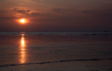 sunset during low-tide at the beach.