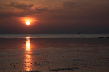 sunset during low-tide at the beach.