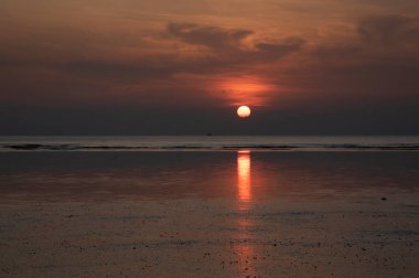 sunset during low-tide at the beach.