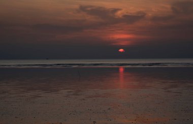 sunset during low-tide at the beach.