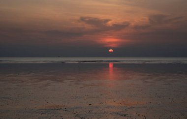 sunset during low-tide at the beach.