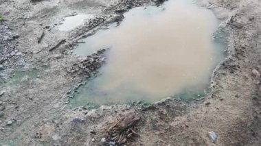 scene of the sizable rounded water-filled depression in the agriculture land.