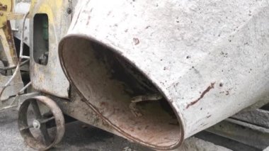 several old cement mixer machines left by the roadside.