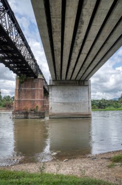 the tall railway bridge crossing the river.
