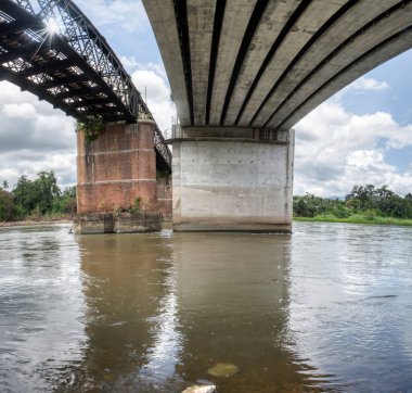 the tall railway bridge crossing the river.