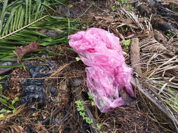 one used pink plastic garbage bag thrown at the isolated rural ground site.