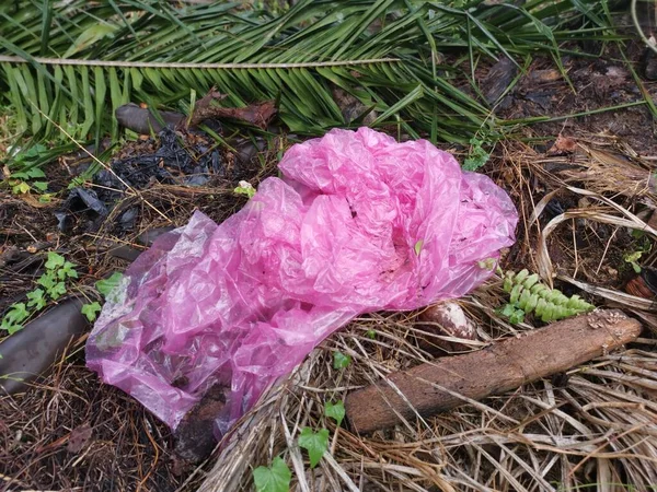 one used pink plastic garbage bag thrown at the isolated rural ground site.
