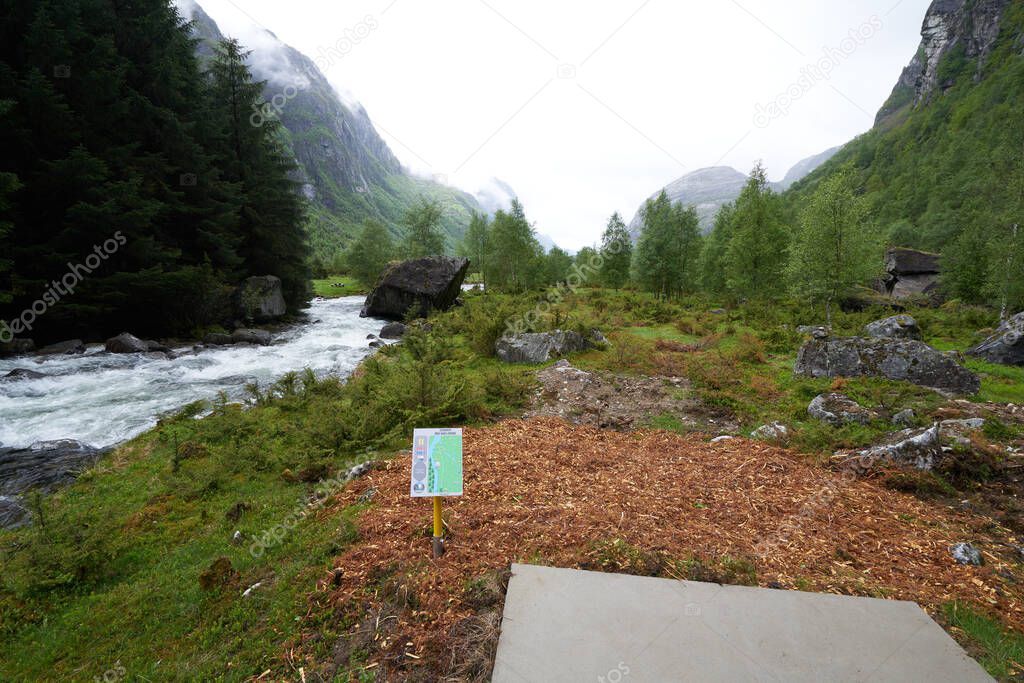 Disc golf tee off zone for two different holes. Concrete pad with hole maps and par listings in Norway at the lysebotn fjord
