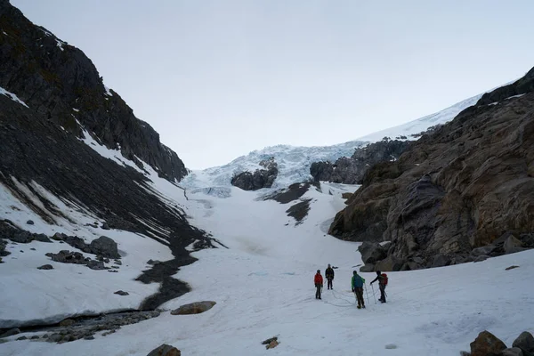 Arka planda Tur Rehberi, Norveç yakınlarındaki Buarbreen buzulunda yürüyüş.