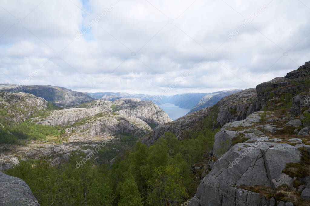 Breathtaking landscape of Preikestolen rock in Norway with Lysefjord fjord on backgrond, in a clear summer day.
