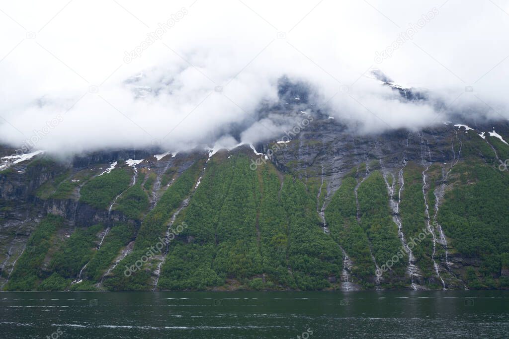 GEIRANGER, NORWAY - 2020 JUNE 21. The famous Seven Sisters waterfall in the Geiranger Fjord.