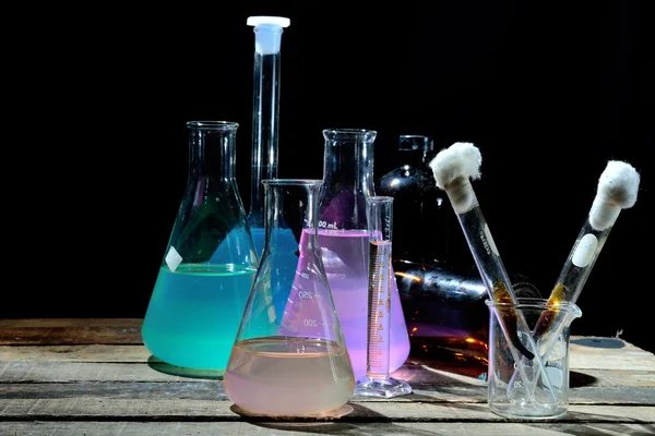 Volumetric laboratory glassware containing colored liquids — Stock Photo, Image