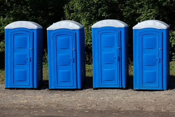 Four Blue Plastic Portable Toilet Stalls Park — Stock Photo, Image