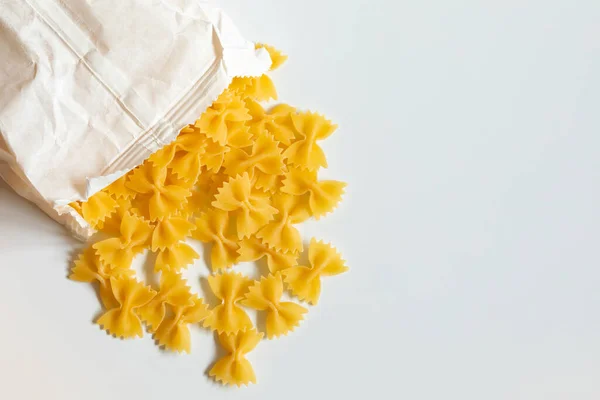 Whole Grain Farfalle Pasta Spilled Out White Paper Bag White — Fotografia de Stock