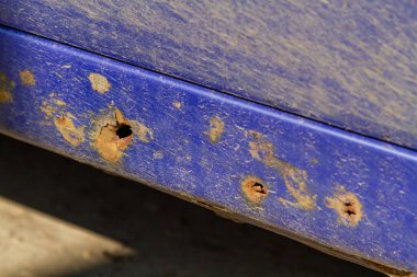 Corrosion and rust of a car. Rust destroyed a threshold of a blue car. Close-up.