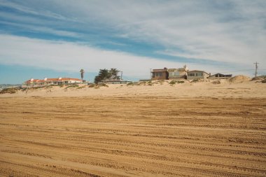 Wide sandy beach and hotels with ocean view in small beach town
