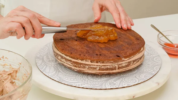 Woman Topping Cake Apricot Jam Step Step Baking Process Chocolate — Fotografia de Stock