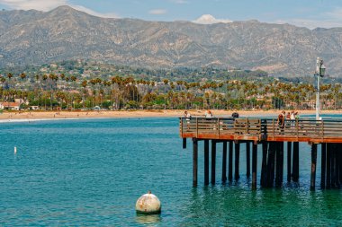 Santa Barbara, California, USA - August 1, 2022  Santa Barbara wharf, ocean view, palm trees, mountains, and cloudy sky background