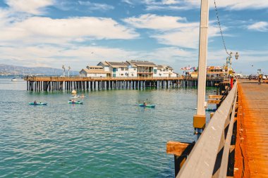 Santa Barbara, California, USA - August 1, 2022  Santa Barbara wharf with walking people, ocean view, and cloudy sky background