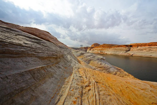 The Chains, Glen Canyon, Arizona. Red rocks, Lake Powell and Glen Canyon dam with cloudy sky on background