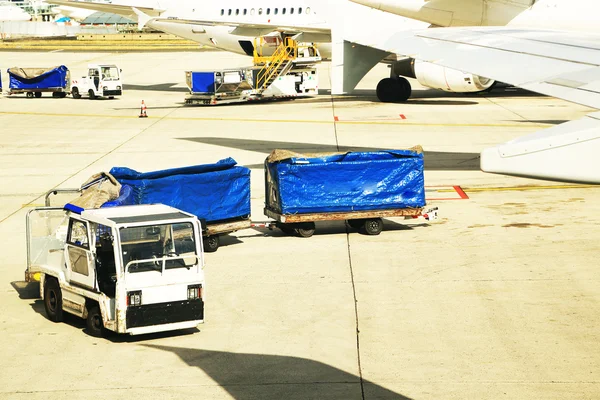 Loading of luggage in an airplane on an airport Stock Picture