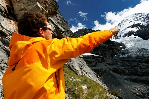 Alpinist contemplating the Eiger Glacier, Switzerland — Stock Photo, Image