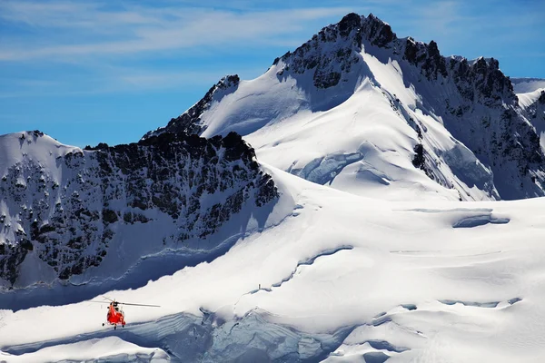 Mountain rescue helikopter over een gletsjerspleet — Stockfoto