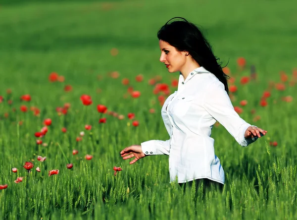 Young brunette beautiful girl enjoying the spring flowers — Stock Photo, Image