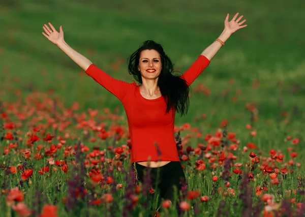 Young brunette beautiful girl enjoying the spring flowers — Stock Photo, Image