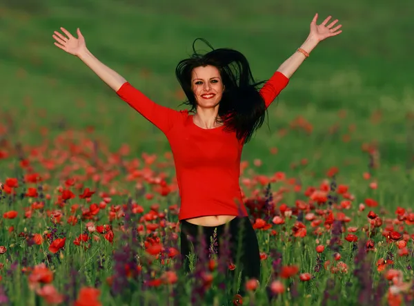 Young brunette beautiful girl enjoying the spring flowers — Stock Photo, Image