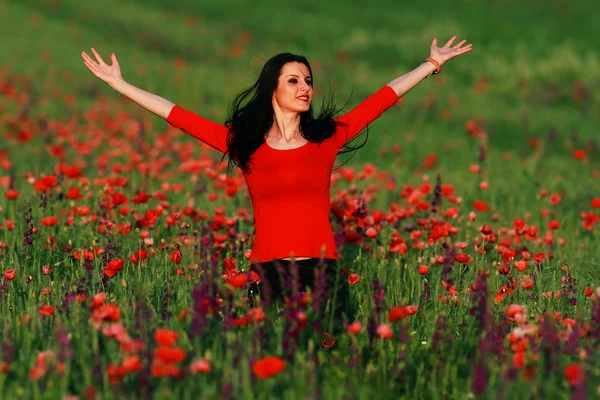 Young brunette beautiful girl enjoying the spring flowers — Stock Photo, Image