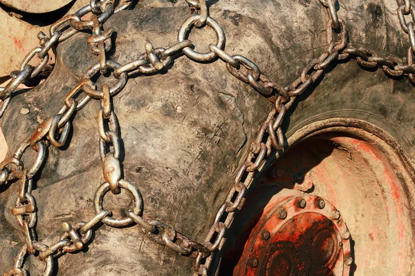 Snow chains on a tractor wheel — Stock Photo, Image