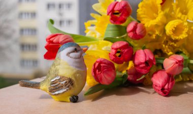 Kırmızı laleler ve Sarı Narcissus güzel bir bahar buketinde. Bahar Çiçeği Kasaba Manzarasına Karşı Bir Pencerede