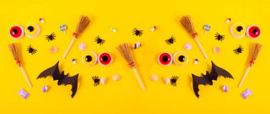 Happy Halloween Banner background with Flat lay composition of Pumpkins, Spiders, and Bats. Halloween Festive backdrop with copy space.