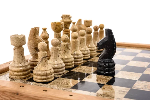chess pieces as rivals, in centre on beige and black coral marble chessboard. Close up game concept competition, Classic Tournament.