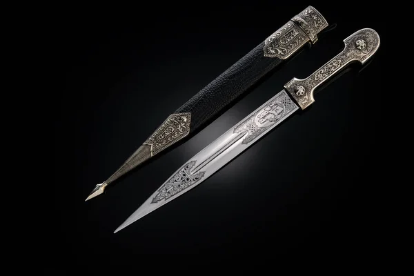 souvenir collectible silver dagger with scabbard on black. Luxury weapons with traditional Celtic patterns in a medieval vintage style.