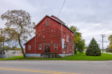 Eau Claire, Michigan, USA - October 21, 2021: a very old red barn on Main street