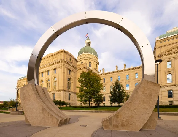 stock image Indianapolis, Indiana, USA - October 19, 2021: The Indiana State Capitol seen across the sculpture by Dale Enochs known as Time Flow