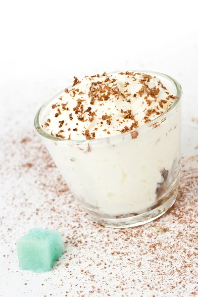 White cup of whipped cream with chocolate, on a white background — Stock Photo, Image