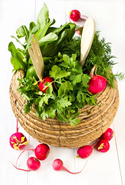 Fresh parsley, dill and radish in a wicker basket on white woode — Stock Photo, Image