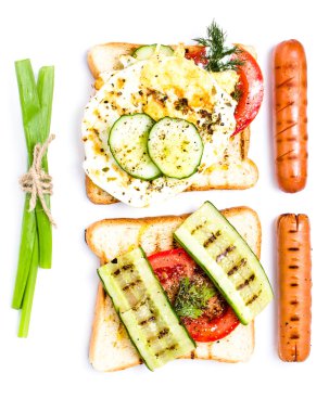Breakfast set of sandwich ingredients with bread, tomato, sausage and herbs, isolated on white background