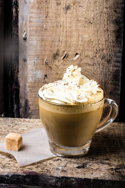 Coffee in glass cup with cream and sprinkled chocolate. — Stock Photo, Image