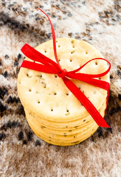 Christmas holiday pile with cookies with red ribbon on knitted mitten. — Stock Photo, Image