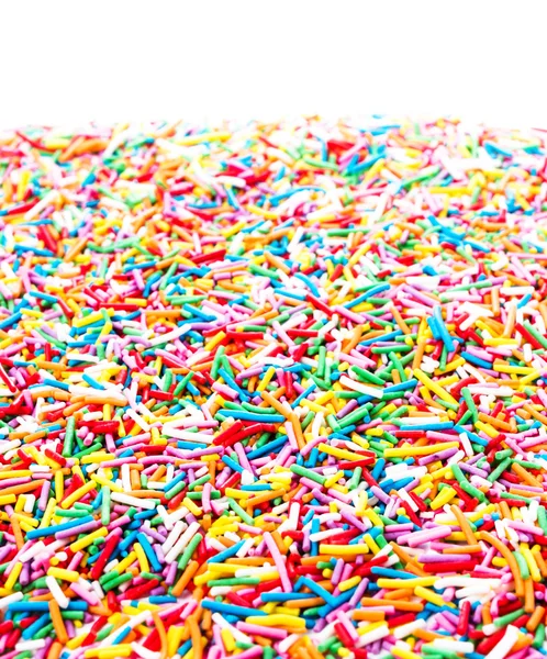 Sprinkles doces coloridos isolados no fundo branco — Fotografia de Stock