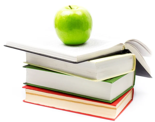 Stack of open books with green apple on white background. — Stock Photo, Image