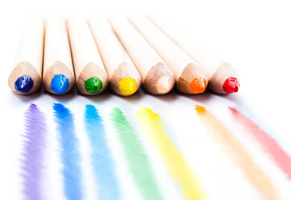 Muchos lápices de arco iris de diferentes colores útiles escolares sobre fondo blanco . — Foto de Stock